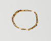 18k solid Gold chain link bracelet on a light gray background