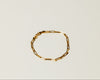 Classic Gold chain link bracelet on a light beige background