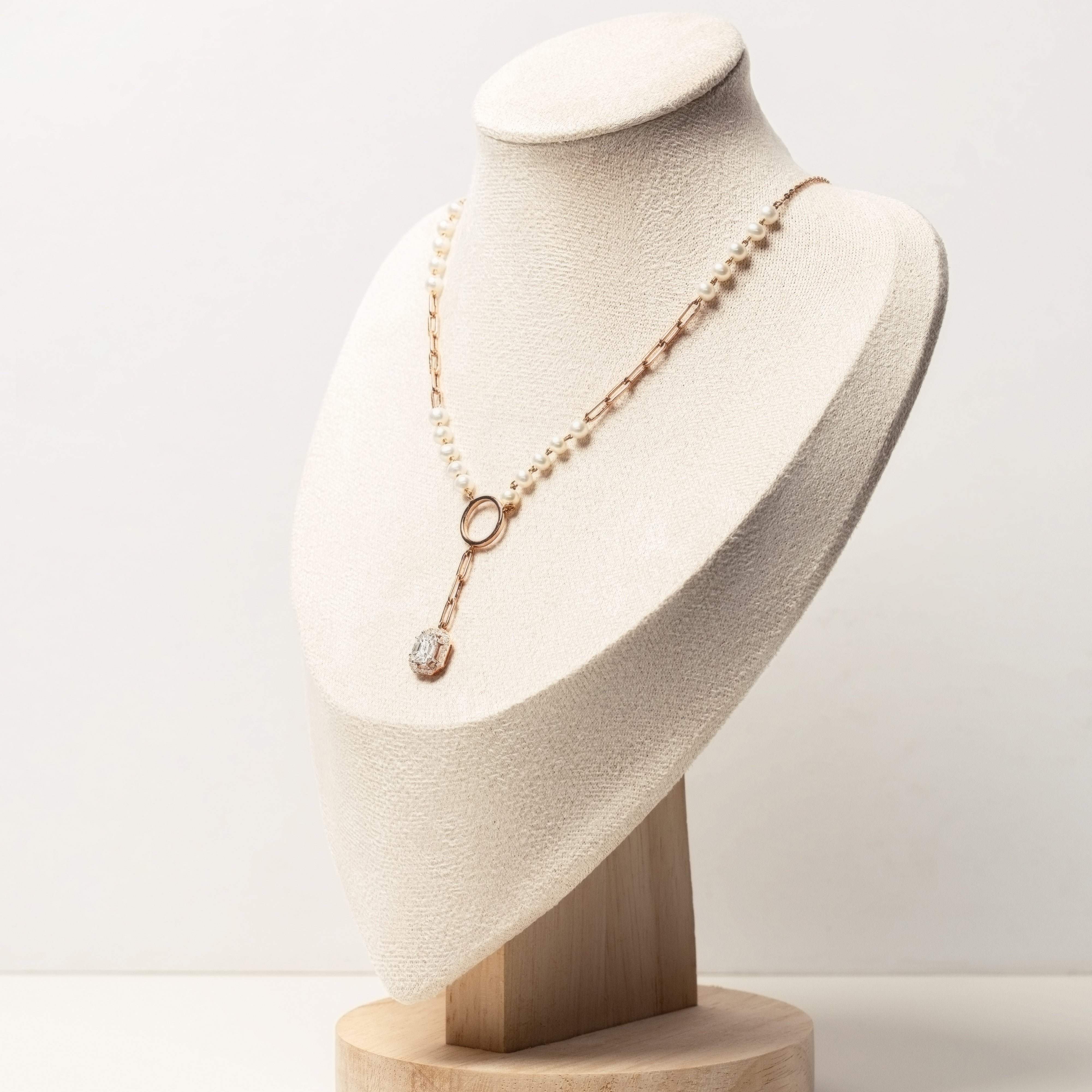 rose gold necklace with diamonds and pearls on mannequin